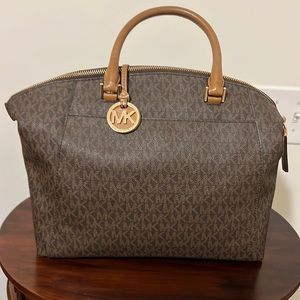Michael Kors handbag. Dark brown in color with signature MK embossing.